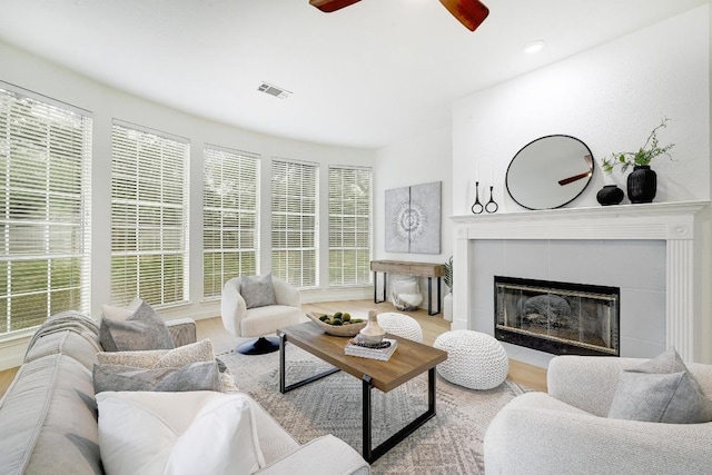 6116 Pebble Garden Ct, Austin, TX 78739 - living room with a tiled fireplace, wood finished floors, and ceiling fan
