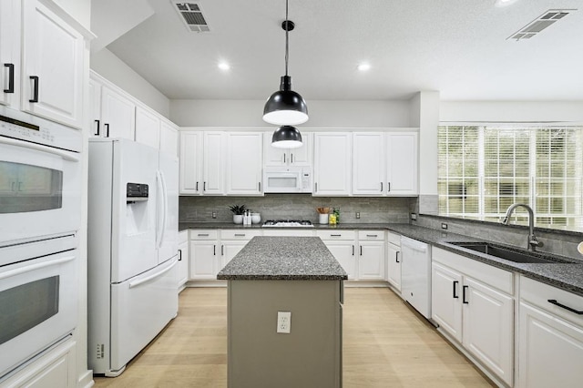 6116 Pebble Garden Ct, Austin, TX 78739 - kitchen featuring white appliances, a sink, white cabinets, and recessed lighting