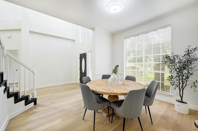 6116 Pebble Garden Ct, Austin, TX 78739 - dining space featuring stairs, ornamental molding, light wood-style floors, and baseboards