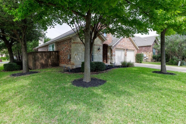 4308 Clear Meadow Pl, Round Rock, TX 78665 - view of front of house featuring concrete driveway, a front lawn, stone siding, and an attached garage