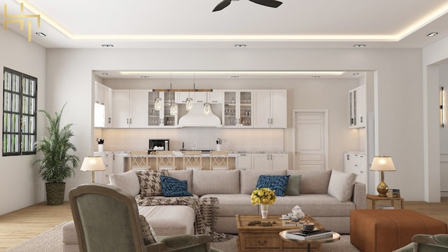 141 Hill Cv, Dripping Springs, TX 78620 - living area with light wood-type flooring, a ceiling fan, and a tray ceiling