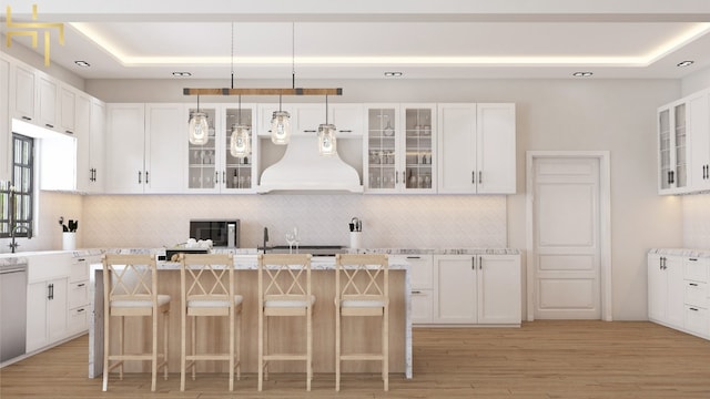 141 Hill Cv, Dripping Springs, TX 78620 - kitchen featuring exhaust hood, light wood finished floors, backsplash, and a kitchen island with sink