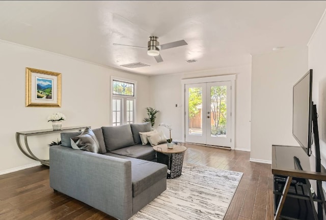 1202 Loma Dr, Austin, TX 78741 - living room with ceiling fan, dark wood finished floors, baseboards, and french doors