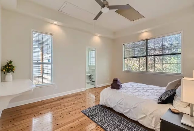 1202 Loma Dr, Austin, TX 78741 - bedroom with attic access, multiple windows, hardwood / wood-style floors, and recessed lighting