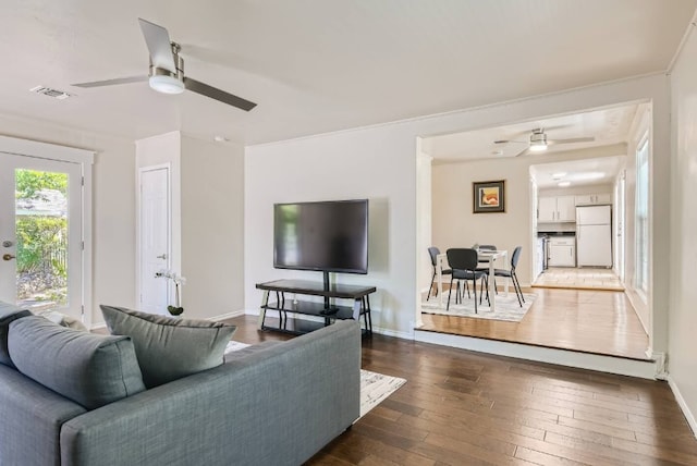 1202 Loma Dr, Austin, TX 78741 - living room featuring ceiling fan, dark wood-style floors, and baseboards