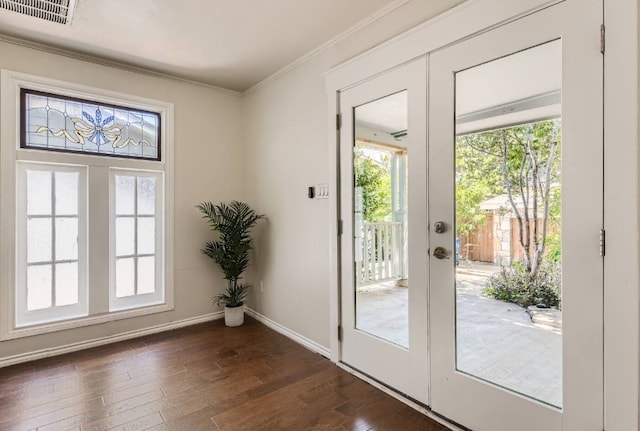 1202 Loma Dr, Austin, TX 78741 - entryway with dark wood-style floors, ornamental molding, and baseboards