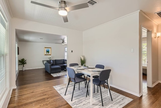 1202 Loma Dr, Austin, TX 78741 - dining space with ceiling fan, wood finished floors, ornamental molding, and baseboards
