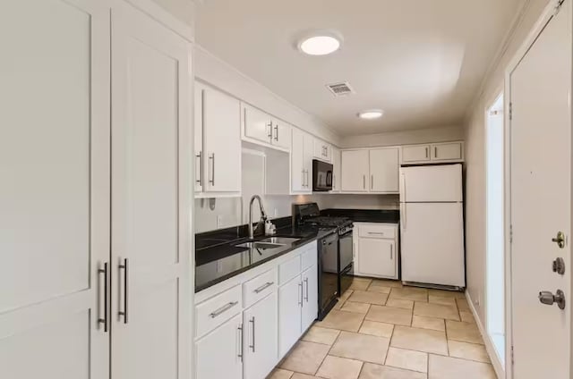 1202 Loma Dr, Austin, TX 78741 - kitchen with black appliances, a sink, dark countertops, and white cabinets