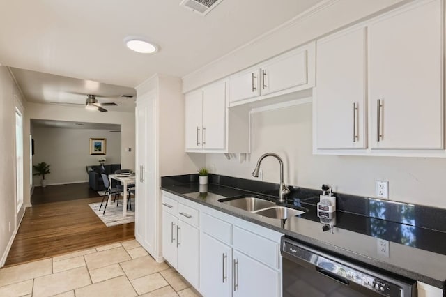 1202 Loma Dr, Austin, TX 78741 - kitchen featuring dishwasher, a sink, dark countertops, white cabinetry, and ceiling fan