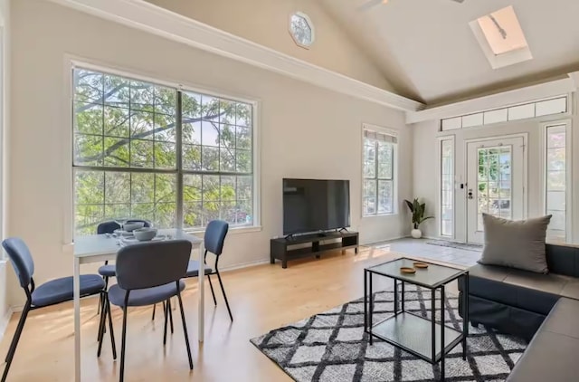 1202 Loma Dr, Austin, TX 78741 - living area with vaulted ceiling, a skylight, and wood finished floors