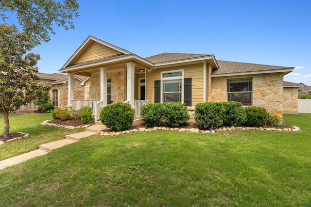 1610 Discovery Blvd, Cedar Park, TX 78613 - view of front of home with stone siding, a front yard, and a porch