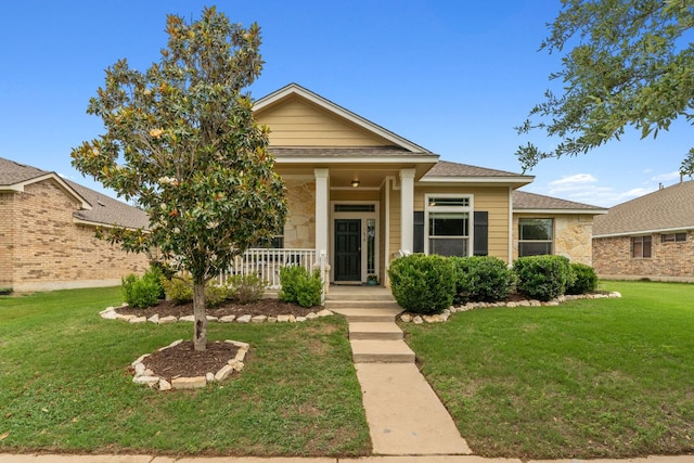 1610 Discovery Blvd, Cedar Park, TX 78613 - view of front of property with covered porch, a front lawn, stone siding, and roof with shingles
