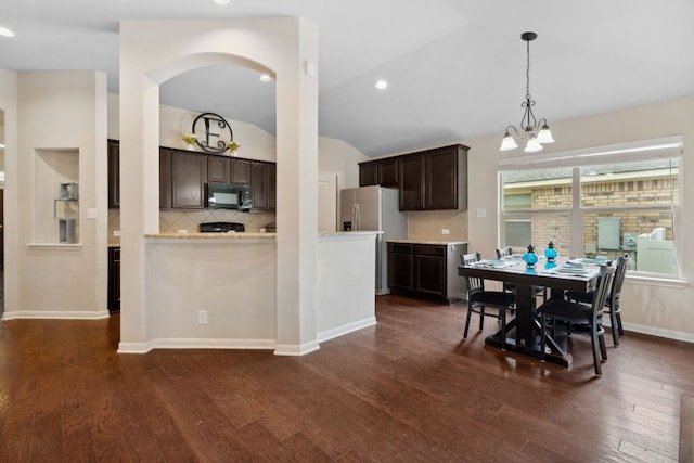 1610 Discovery Blvd, Cedar Park, TX 78613 - dining room with vaulted ceiling, a chandelier, dark wood finished floors, arched walkways, and recessed lighting
