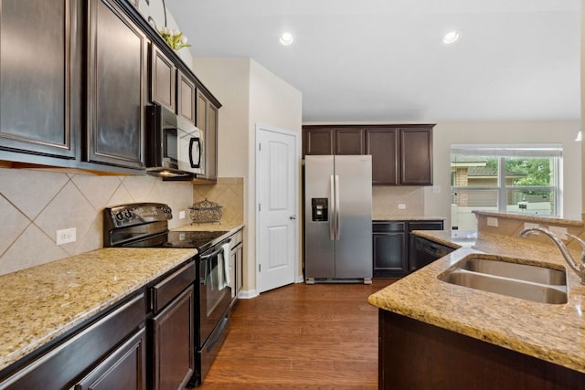 1610 Discovery Blvd, Cedar Park, TX 78613 - kitchen featuring appliances with stainless steel finishes, a sink, dark wood-style floors, dark brown cabinets, and light stone countertops