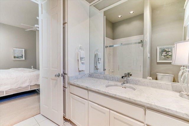 6012 Messenger Stake, Austin, TX 78746 - bathroom featuring vanity, a stall shower, toilet, connected bathroom, and tile patterned floors