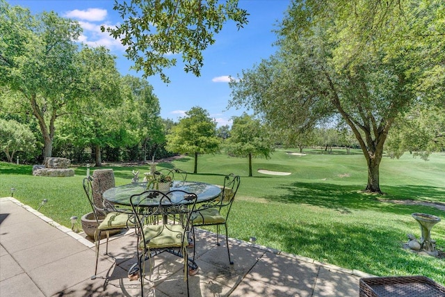 6012 Messenger Stake, Austin, TX 78746 - view of patio with view of wooded area and outdoor dining area