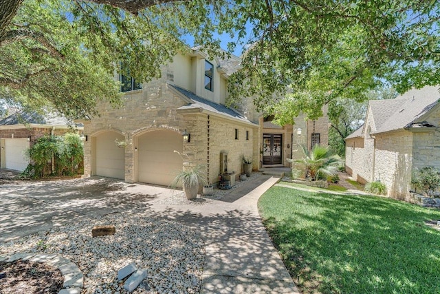 6012 Messenger Stake, Austin, TX 78746 - view of front of home with an attached garage, french doors, stone siding, stucco siding, and a front lawn