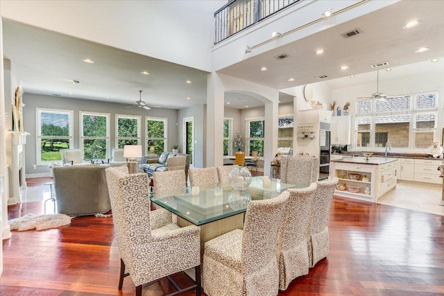 6012 Messenger Stake, Austin, TX 78746 - dining space with light wood finished floors, a ceiling fan, arched walkways, and recessed lighting