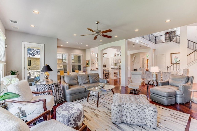 6012 Messenger Stake, Austin, TX 78746 - living room featuring arched walkways, wood finished floors, a ceiling fan, recessed lighting, and stairway