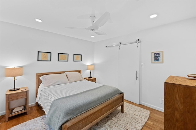 4839 Canyonbend Cir, Austin, TX 78735 - bedroom featuring a barn door, light wood finished floors, baseboards, recessed lighting, and a ceiling fan