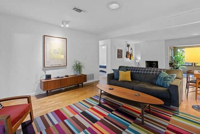 4839 Canyonbend Cir, Austin, TX 78735 - living area featuring light wood-type flooring, a fireplace, and baseboards