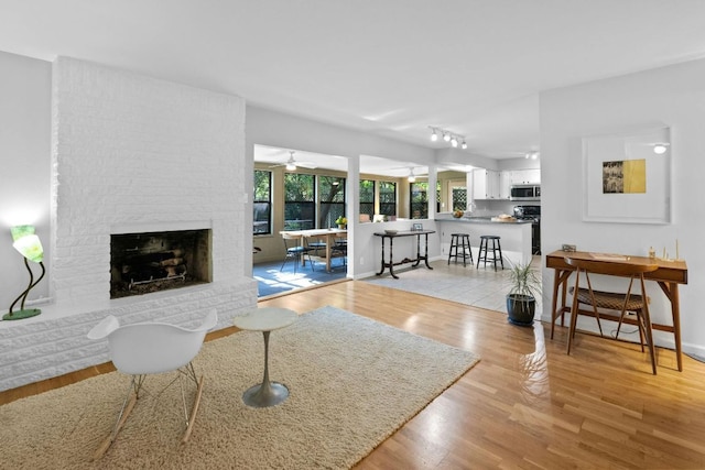 4839 Canyonbend Cir, Austin, TX 78735 - living area with a fireplace, wood finished floors, baseboards, and a ceiling fan