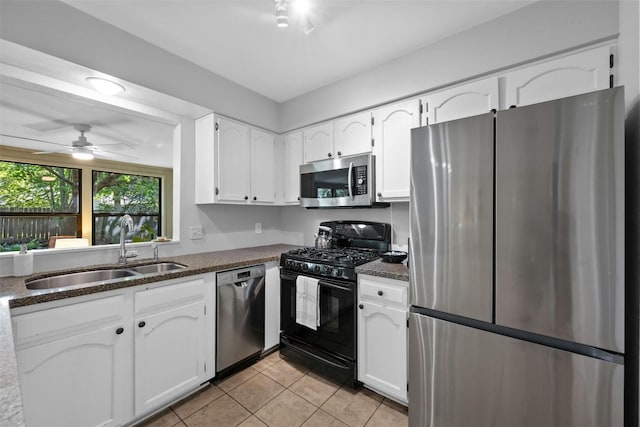 4839 Canyonbend Cir, Austin, TX 78735 - kitchen with stainless steel appliances, a sink, light tile patterned flooring, white cabinetry, and a ceiling fan