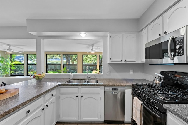 4839 Canyonbend Cir, Austin, TX 78735 - kitchen with appliances with stainless steel finishes, a sink, ceiling fan, and white cabinetry