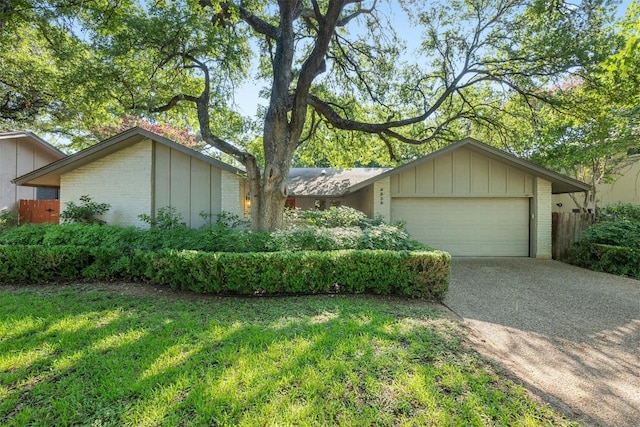 4839 Canyonbend Cir, Austin, TX 78735 - view of front facade featuring driveway, board and batten siding, brick siding, and a garage