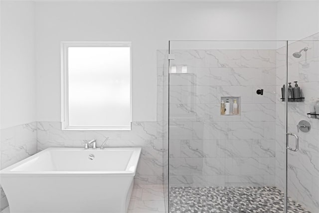 216 Reata Ridge Loop, Liberty Hill, TX 78642 - bathroom featuring a shower stall, marble finish floors, and a freestanding tub