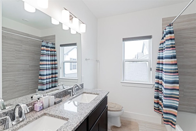 216 Reata Ridge Loop, Liberty Hill, TX 78642 - bathroom with baseboards, toilet, double vanity, and shower / bath combination with curtain