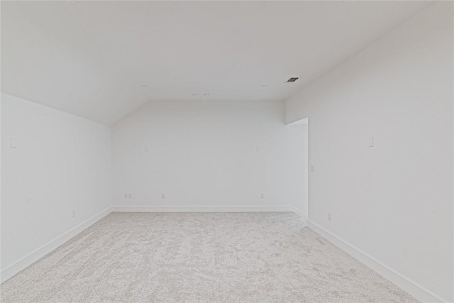 216 Reata Ridge Loop, Liberty Hill, TX 78642 - spare room featuring lofted ceiling, light colored carpet, and baseboards