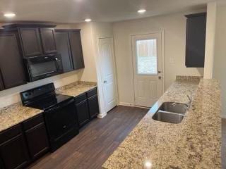 11605 Claudette St, San Antonio, TX 78252 - kitchen with black appliances, dark wood-type flooring, a sink, recessed lighting, and light stone countertops