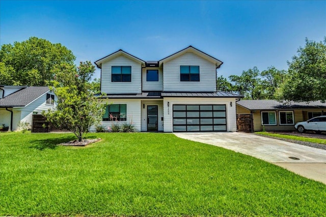 3004 Hunt Trl, Austin, TX 78757 - view of front of house with a standing seam roof, an attached garage, concrete driveway, a front yard, and metal roof