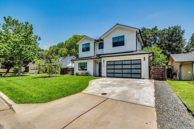 3004 Hunt Trl, Austin, TX 78757 - view of front of home featuring driveway, a garage, a standing seam roof, and metal roof