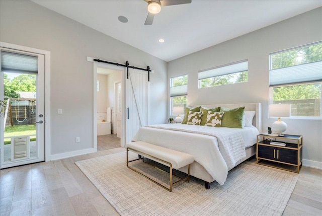 3004 Hunt Trl, Austin, TX 78757 - bedroom featuring a barn door, access to outside, light wood-type flooring, vaulted ceiling, and baseboards