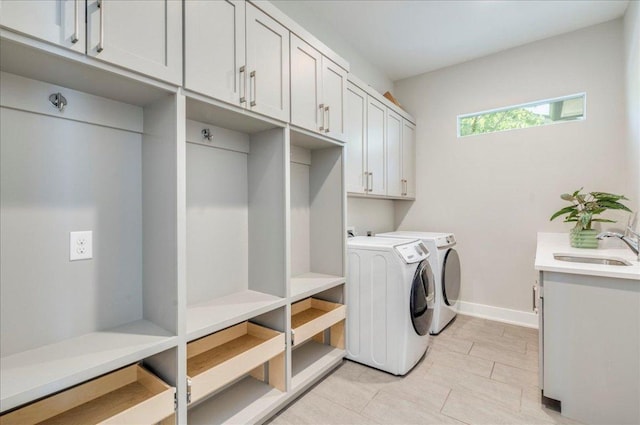 3004 Hunt Trl, Austin, TX 78757 - laundry room featuring cabinet space, independent washer and dryer, light tile patterned floors, and baseboards