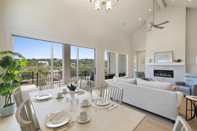 19401 Summit Glory Trl Unit 80, Spicewood, TX 78669 - dining room with high vaulted ceiling, a glass covered fireplace, healthy amount of natural light, beamed ceiling, and ceiling fan