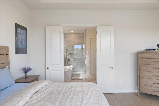 19401 Summit Glory Trl Unit 80, Spicewood, TX 78669 - bedroom with wood finished floors, baseboards, and ensuite bath