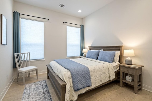 19401 Summit Glory Trl Unit 80, Spicewood, TX 78669 - bedroom featuring multiple windows, wood finished floors, baseboards, and recessed lighting