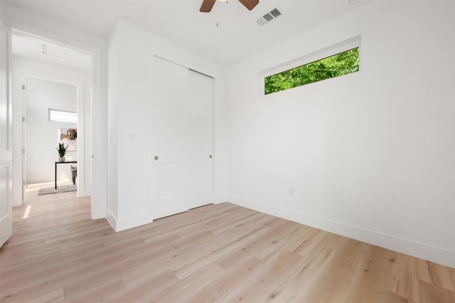 106 W Croslin St Unit B, Austin, TX 78752 - unfurnished bedroom with light wood finished floors, a closet, baseboards, and ceiling fan