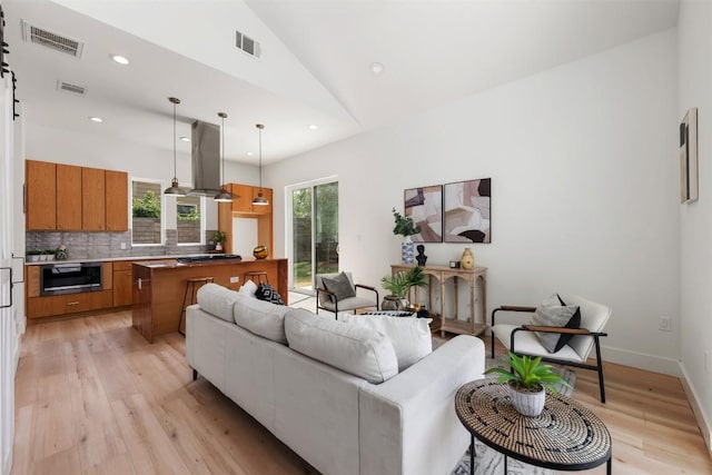 106 W Croslin St Unit B, Austin, TX 78752 - living room with light wood-style floors, lofted ceiling, recessed lighting, and baseboards