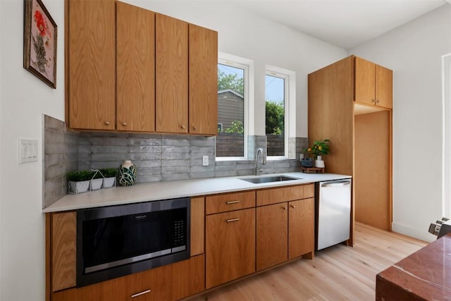 106 W Croslin St Unit B, Austin, TX 78752 - kitchen featuring built in microwave, a sink, dishwasher, light wood-style flooring, and tasteful backsplash