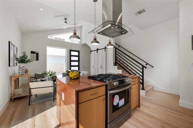 106 W Croslin St Unit B, Austin, TX 78752 - kitchen with stainless steel gas range, island exhaust hood, light wood-type flooring, baseboards, and recessed lighting