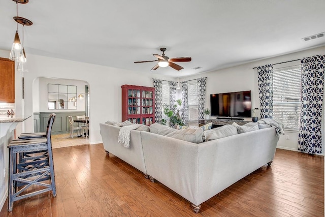 14028 Turkey Hollow Trl, Austin, TX 78717 - living area featuring a ceiling fan, arched walkways, hardwood / wood-style floors, and baseboards