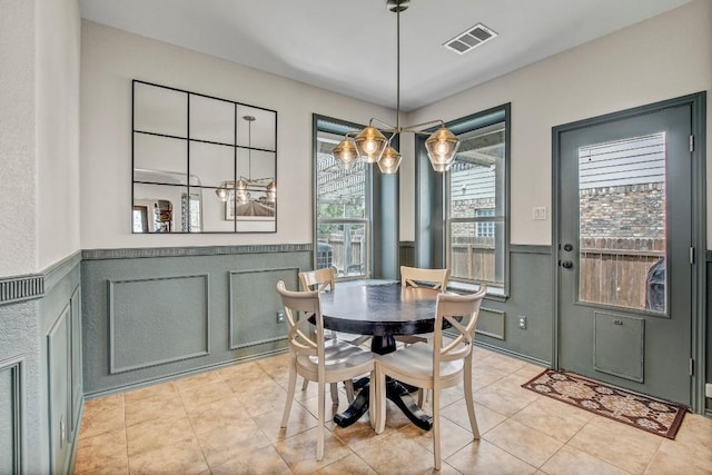 14028 Turkey Hollow Trl, Austin, TX 78717 - dining room featuring a decorative wall, a wainscoted wall, and light tile patterned floors