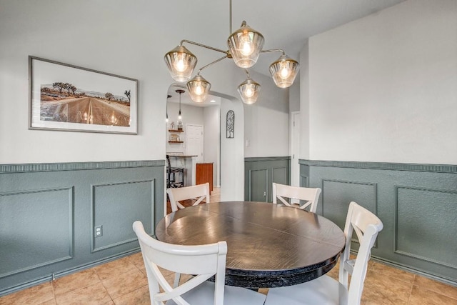 14028 Turkey Hollow Trl, Austin, TX 78717 - dining area featuring wainscoting, light tile patterned floors, and a decorative wall