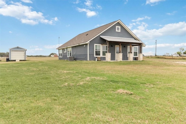 1581 Washburn Rd, Luling, TX 78648 - rear view of property featuring a detached garage, a lawn, and cooling unit