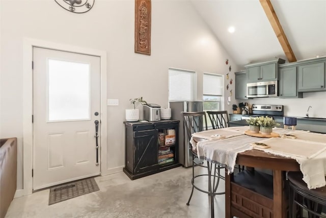 1581 Washburn Rd, Luling, TX 78648 - dining room with concrete flooring, high vaulted ceiling, beamed ceiling, and baseboards