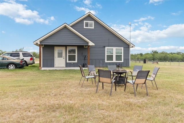 1581 Washburn Rd, Luling, TX 78648 - back of property featuring a yard and an outdoor fire pit